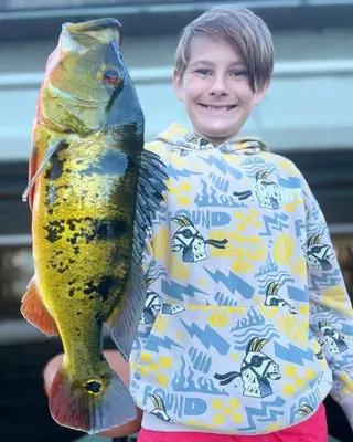 Kid with Big Peacock Bass