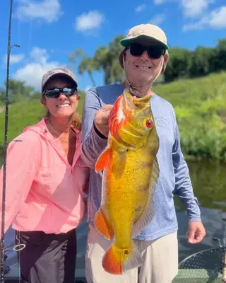 Couple with Peacock Bass
